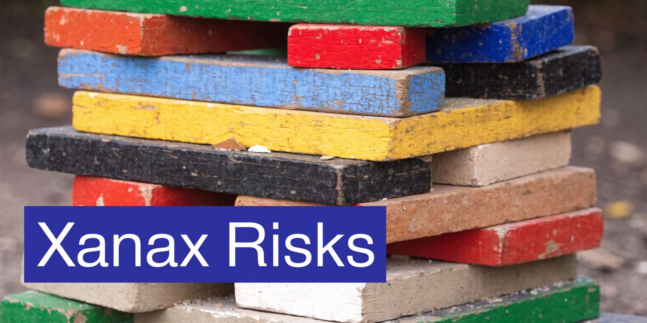 A stack of colorful, weathered wooden blocks with a blue box labeled Xanax Risks overlaid.